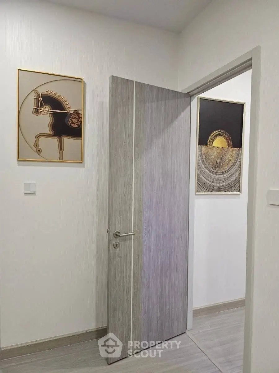 Modern interior with stylish door and elegant wall art in a contemporary home.