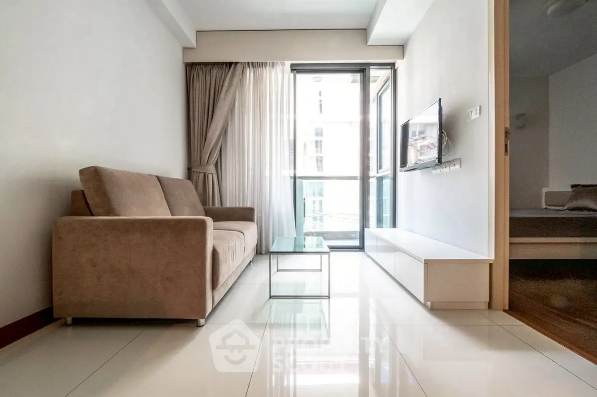 Modern living room with sleek furniture and balcony view