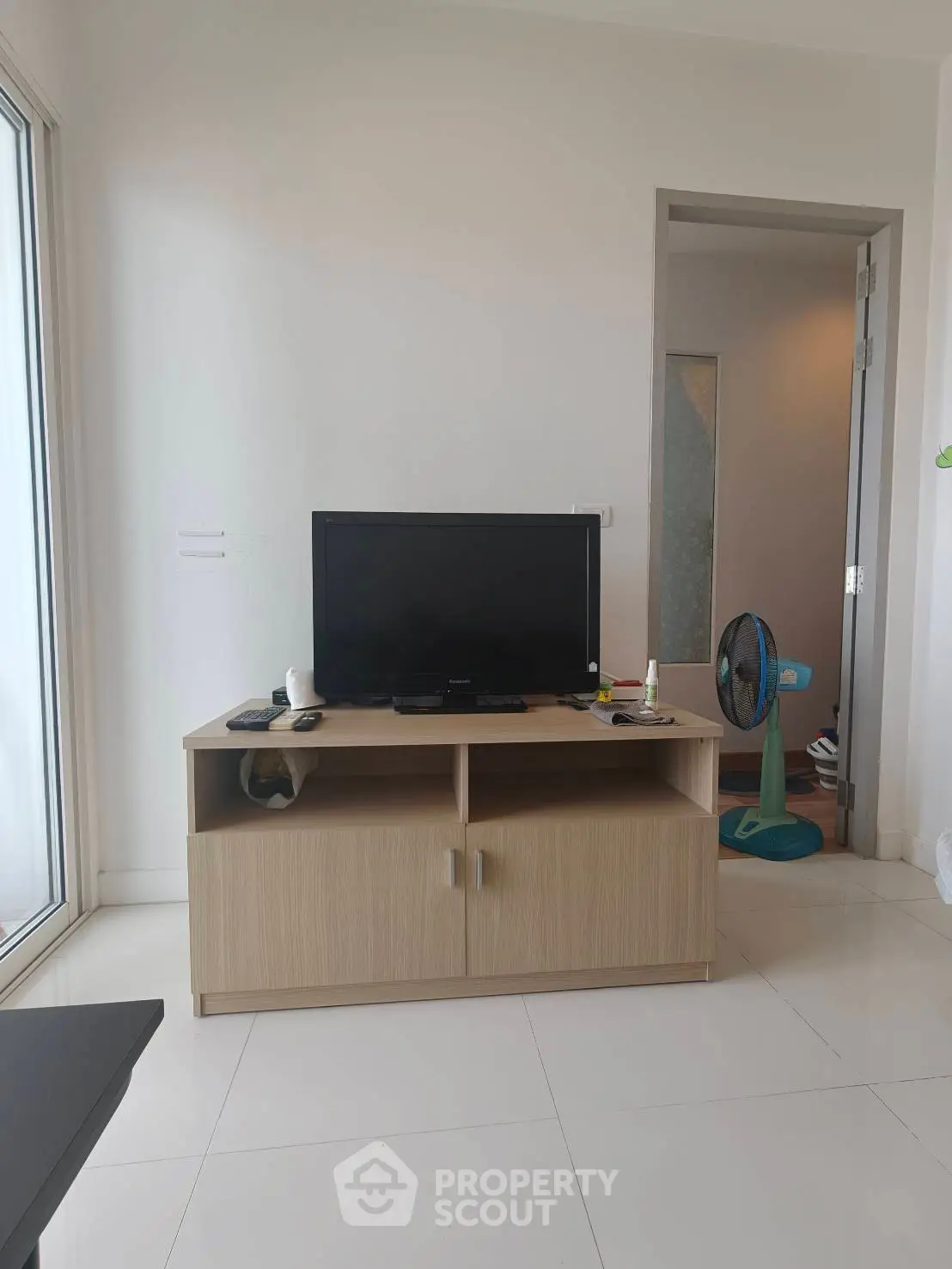 Modern living room with sleek TV stand and minimalist decor, perfect for urban living.