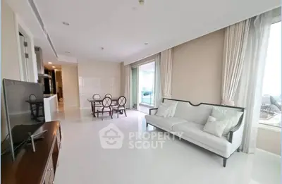 Spacious living room with elegant decor and large windows offering natural light.