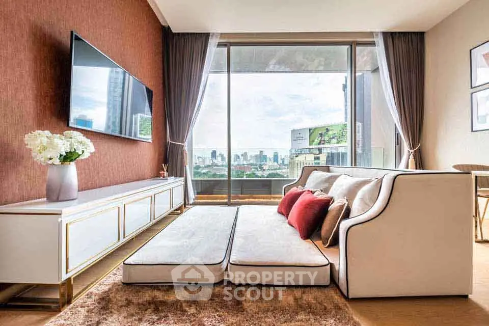Luxurious living room with city view, modern decor, and large TV setup.