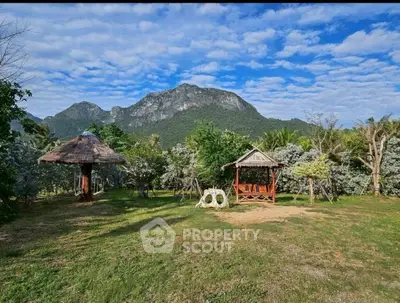 Scenic garden with mountain backdrop and charming gazebos, perfect for relaxation.