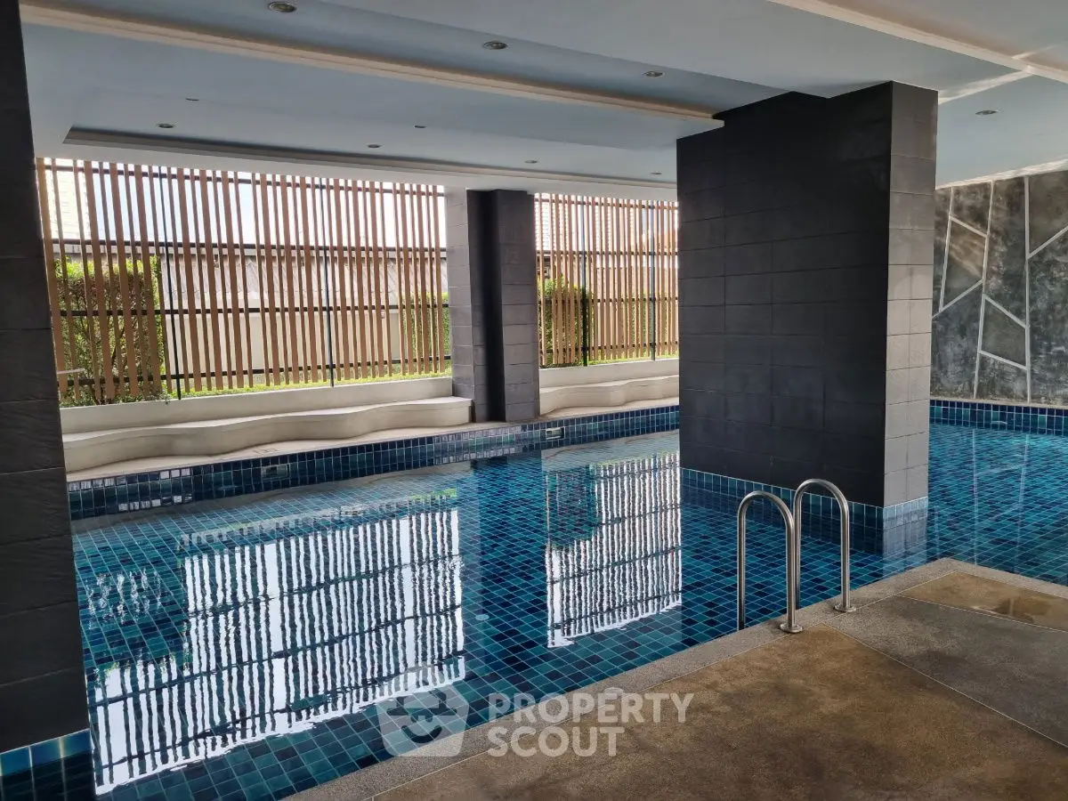 Luxurious indoor pool with modern design and elegant tile work