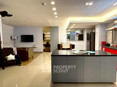 Spacious modern living room with open kitchen and sleek design