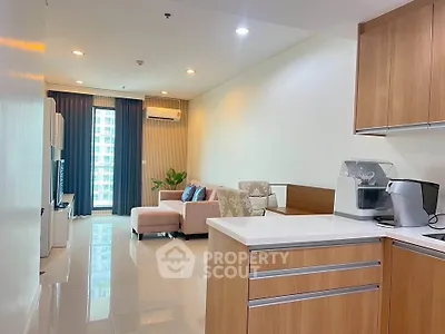 Modern open-plan living room with sleek kitchen and cozy seating area