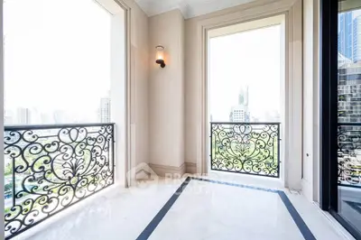 Luxurious balcony with ornate railings and stunning cityscape view, perfect for relaxation and entertainment.
