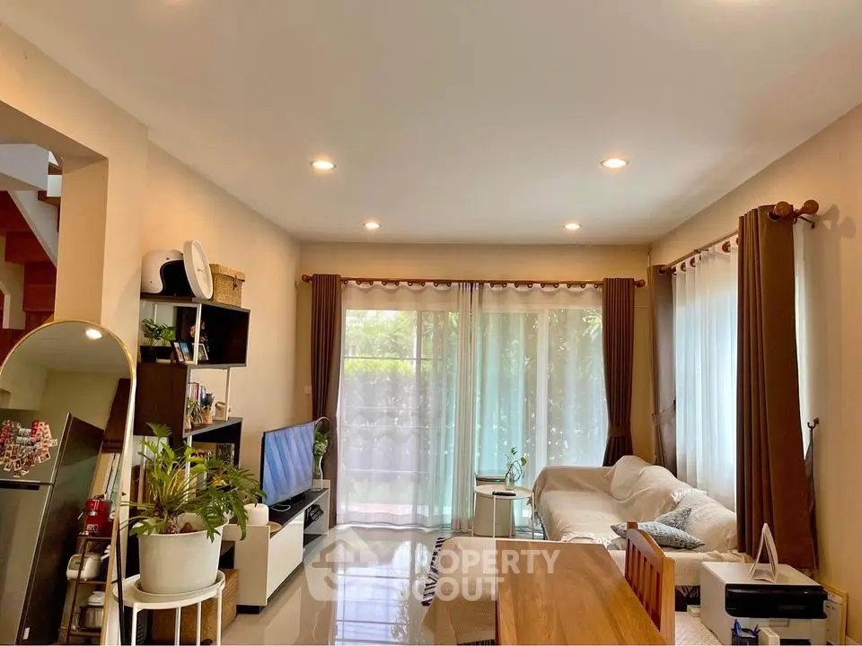 Spacious living room with modern decor and large windows offering natural light.