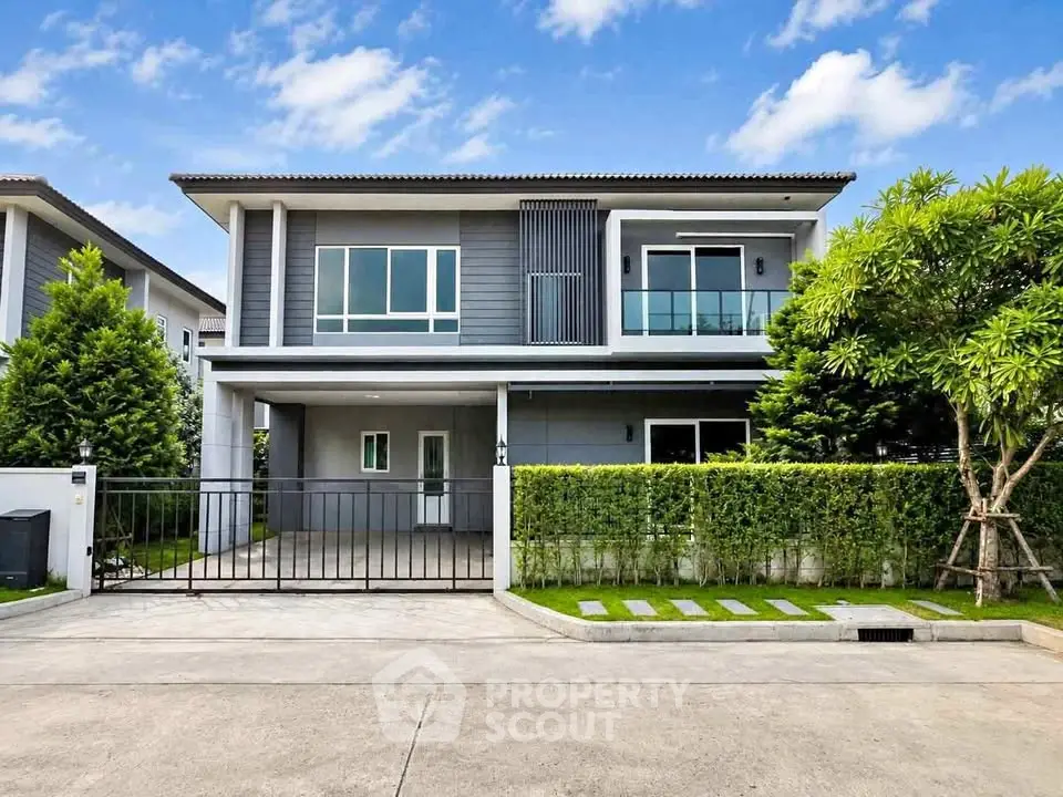 Modern two-story house with sleek design and lush greenery, perfect for contemporary living.