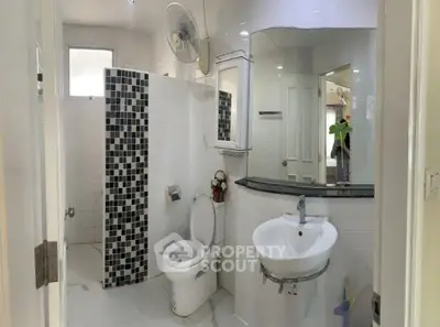 Modern bathroom with stylish black and white tile accents and sleek fixtures