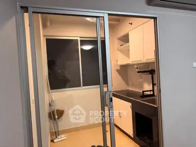 Modern kitchen with sleek cabinets and glass sliding door
