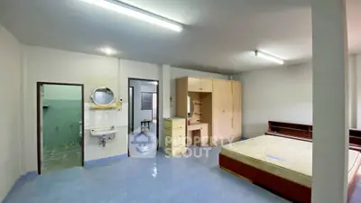 Spacious bedroom with ensuite bathroom and ample storage in modern apartment.