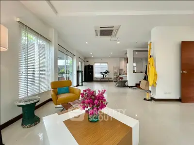 Spacious modern living room with stylish decor and abundant natural light.