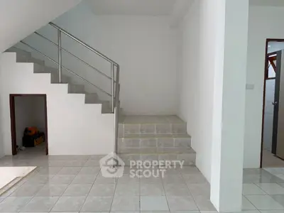 Modern interior with tiled staircase and storage space under stairs