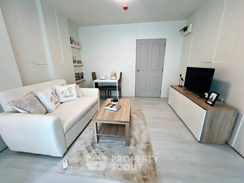 Modern living room with cozy sofa, stylish decor, and sleek TV unit in a contemporary apartment.