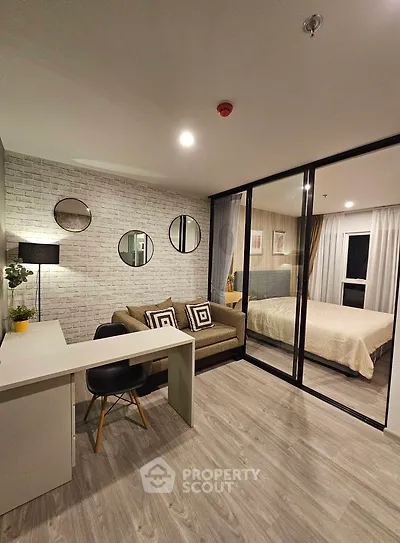 Modern open-plan living room with stylish decor and cozy bedroom view