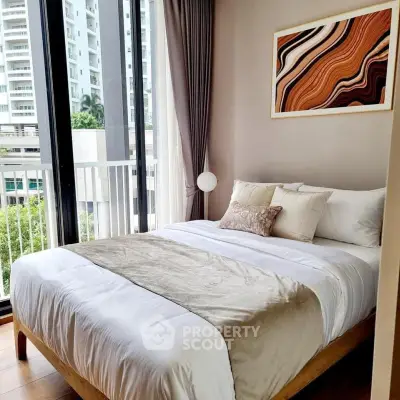 Stylish bedroom with large windows and modern decor in a high-rise apartment.