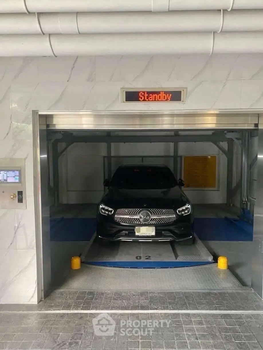 Modern automated parking system with luxury car in sleek garage.