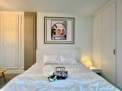 Elegant bedroom with modern decor and cozy ambiance, featuring stylish artwork and soft lighting.