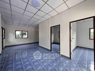 Spacious interior with blue tiled flooring and multiple rooms, ideal for customization.