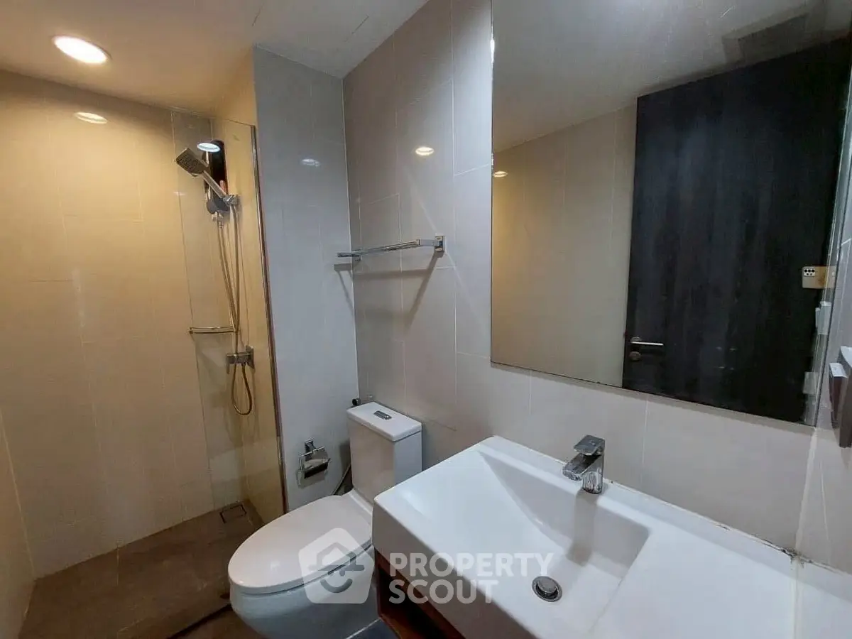 Modern bathroom with sleek fixtures and spacious shower area