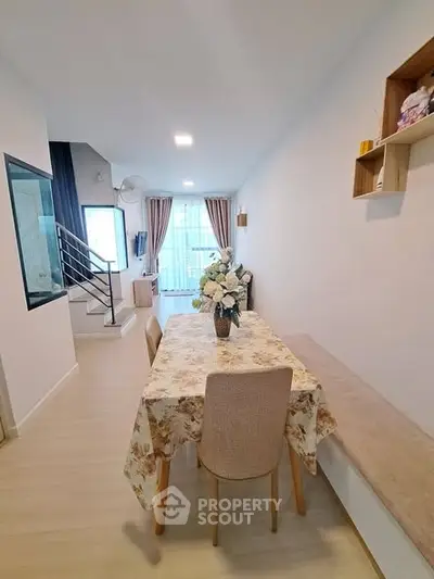 Charming dining area with floral tablecloth and cozy seating in modern home