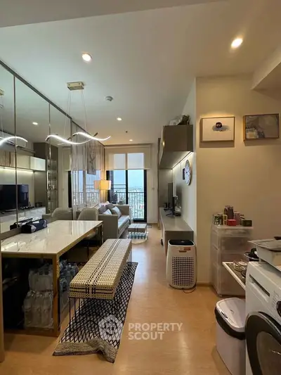 Modern living room with open layout and stylish decor, featuring a large window with a scenic view.