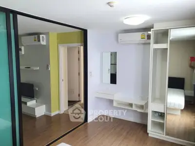 Modern bedroom with mirrored closet and air conditioning in stylish apartment