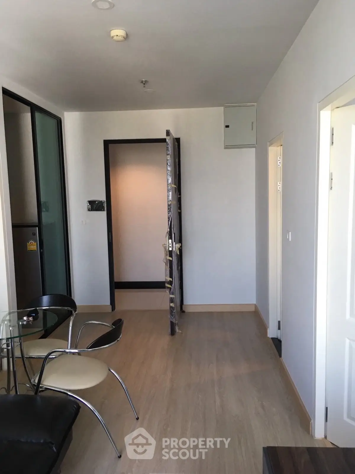 Modern apartment interior with open door and stylish furniture