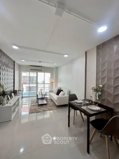 Modern living room with stylish decor and balcony access in a contemporary apartment.