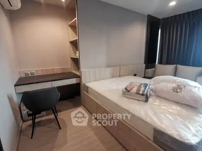 Modern bedroom with sleek design, featuring a cozy bed, built-in desk, and ample storage space.