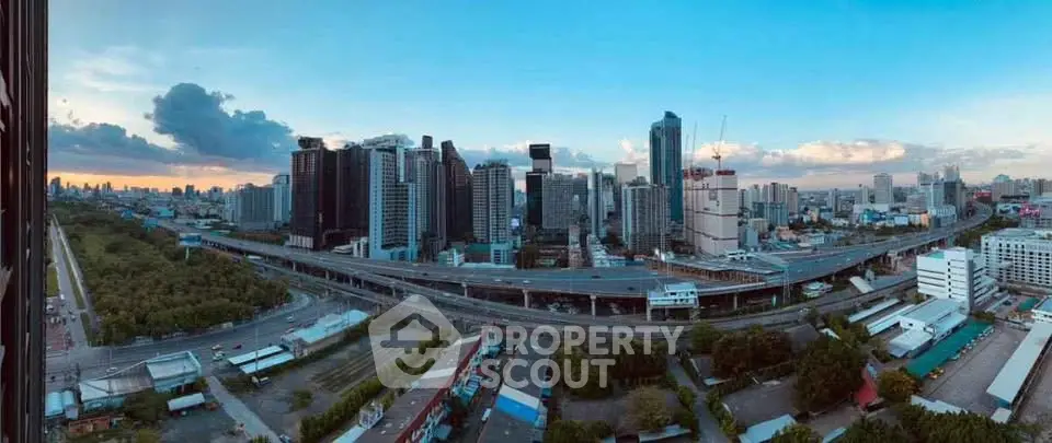 Stunning panoramic cityscape view showcasing modern skyscrapers and urban infrastructure at sunset.