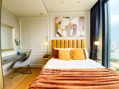 Luxurious bedroom with modern decor and stunning city view, featuring elegant lighting and stylish furnishings.