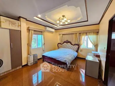 Luxurious bedroom with elegant decor and large windows for natural light.