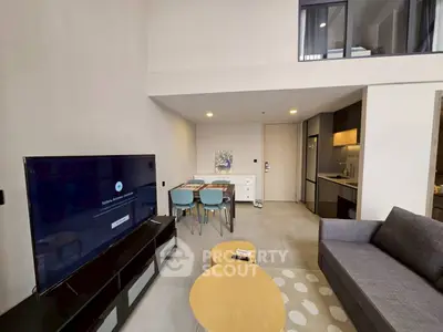 Modern living room with open kitchen and stylish furniture in a spacious apartment.