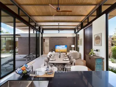 Luxurious open-plan living room with elegant dining area and modern decor