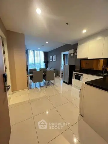 Modern open-layout kitchen and dining area with sleek design and ample natural light.