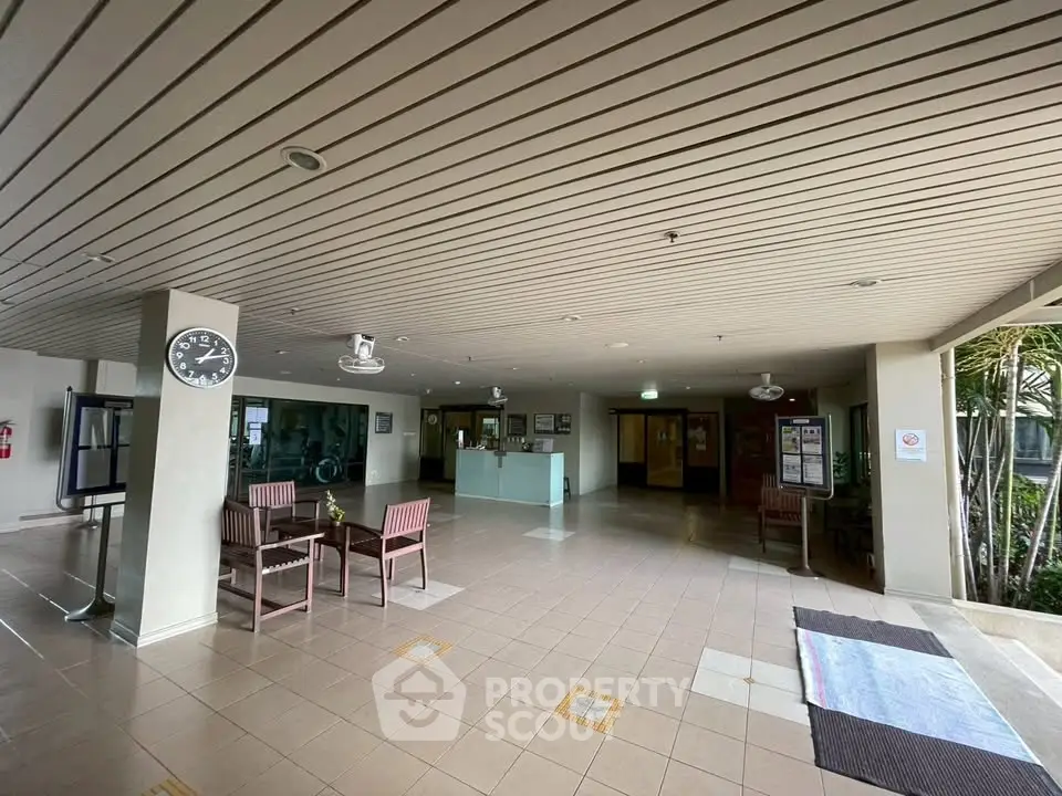 Spacious building entrance with seating area and modern decor