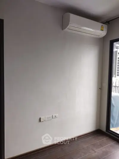 Minimalist room with air conditioner and large window, perfect for modern living.