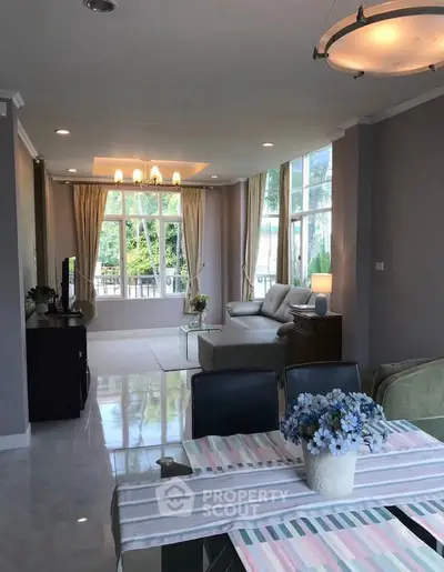 Spacious living room with large windows and elegant decor