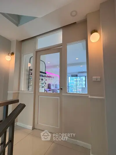 Modern interior with glass door and city view, ideal for urban living.