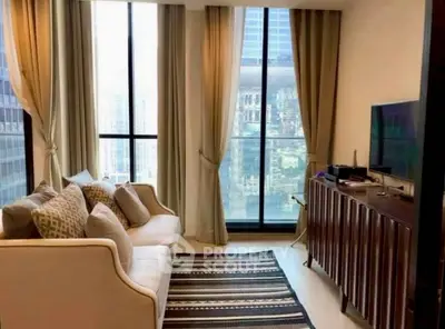 Modern living room with city view, elegant sofa, and stylish decor