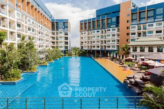 Luxurious apartment complex with expansive pool and modern amenities.
