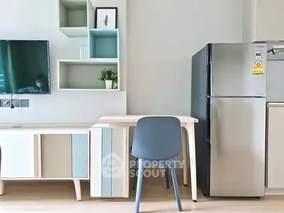 Modern interior with sleek fridge and stylish desk in a bright living space.