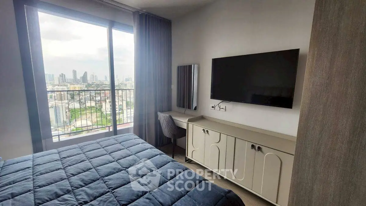Modern bedroom with city view, featuring a large window, stylish decor, and a wall-mounted TV.