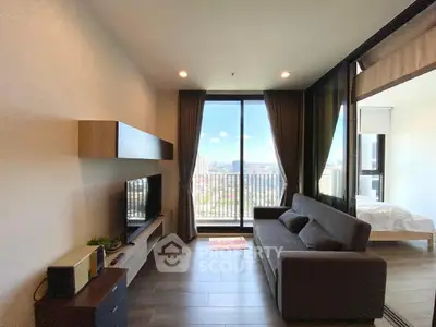 Modern living room with large window offering stunning city view and stylish furnishings.