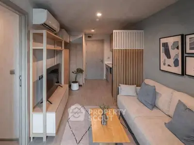 Modern living room with stylish decor and open layout, featuring a cozy sofa and wall-mounted TV.