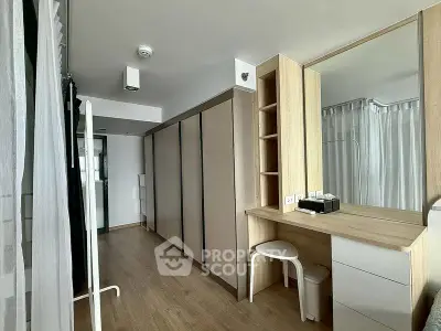 Modern bedroom with sleek wardrobe and vanity in stylish apartment