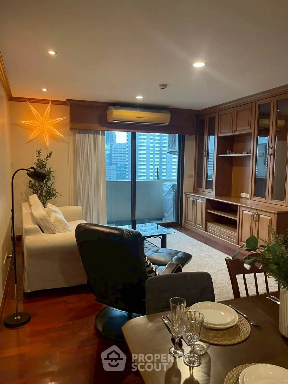 Stylish living room with city view and elegant wooden cabinetry