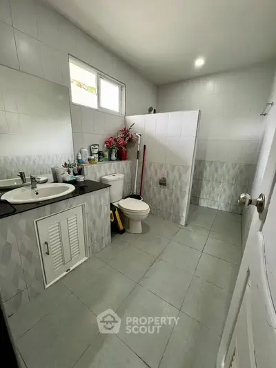 Spacious bathroom with modern fixtures and ample storage space