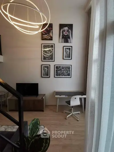 Modern living room with stylish decor and workspace in a cozy apartment